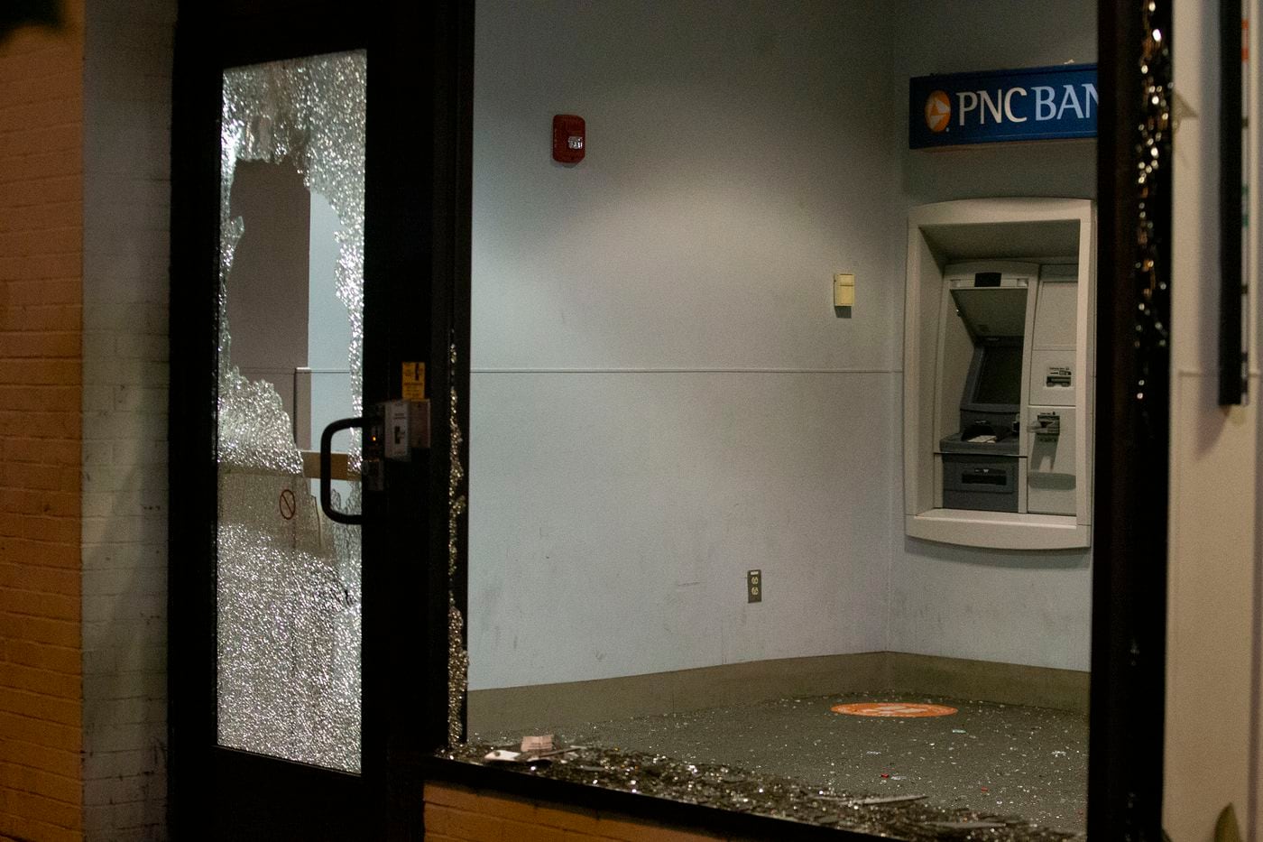 The shattered windows at a PNC Bank branch on 40th Street near Walnut. The windows were destroyed by a group of protesters marching in response to the Jacob Blake shooting in Wisconsin.