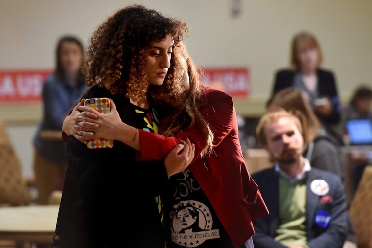 Hillary Clinton supporters Rana Fayez (left) and Lisa Powell Graham hold each other as they watch voter returns at an election night party in Philadelphia November 8, 2016.