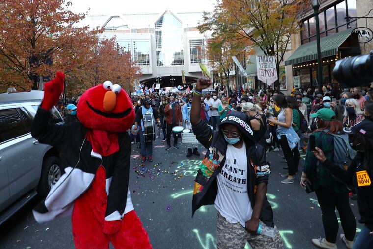 Philly Elmo and the Positive Movement drum line perform with “Count Every Vote” supporters outside of the Pennsylvania Convention Center.