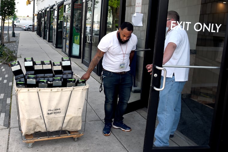 Workers deliver a cart full of ballots from voting machines around the city to the Philadelphia Board of Elections June 4, 2020. On the day after Pennsylvania's primary election, results are taking longer because of a flood of mail-in ballots city officials need to process.