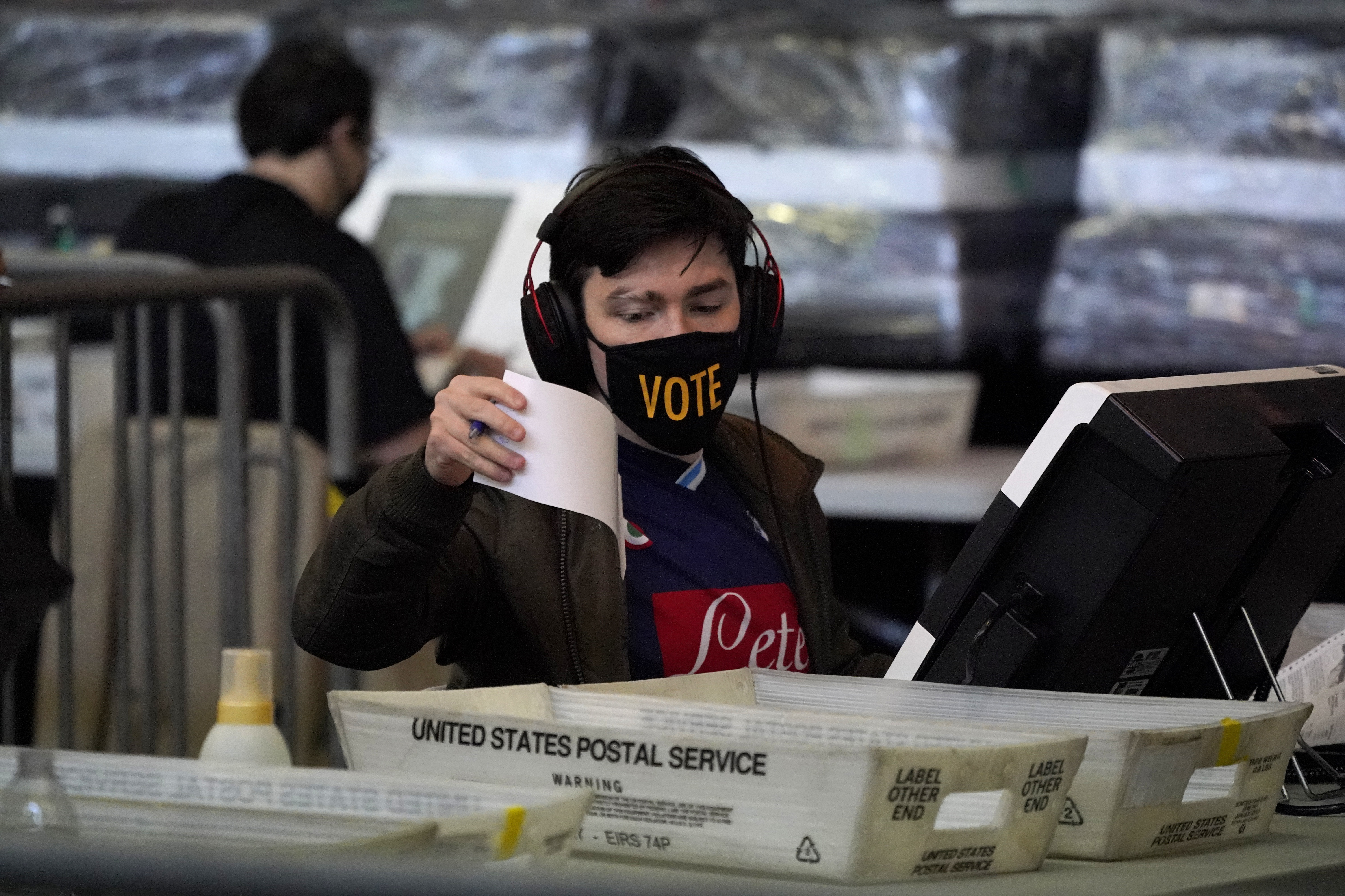 In this Nov. 6, 2020, photo, ballots from the 2020 general election are counted at the Allegheny County Election Division warehouse in Pittsburgh.