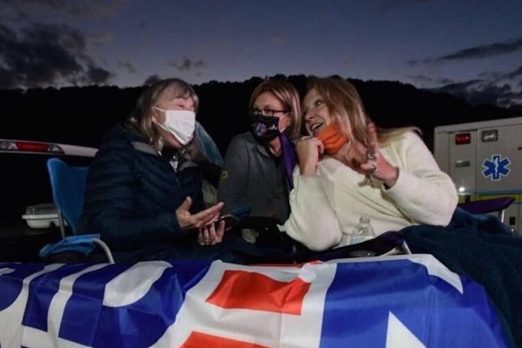 Susan Boser, Barb Peace and Denise Jennings-Doyle in the bed of Peace's truck at a Biden drive-in rally in Johnstown, Pa. Peace has been volunteering for the Indiana County Democratic Committee which has tried to grow support for Biden among rural women.