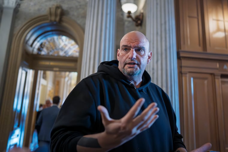 Sen. John Fetterman, D-Pa., talks to reporters outside the chamber during a vote at the Capitol in Washington, Thursday, March 13, 2025.
