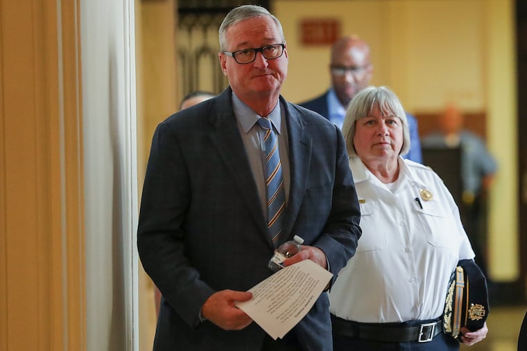Mayor Jim Kenney (left) and new acting Police Commissioner Christine Coulter arrive for a news conference regarding the resignation of former Commissioner Richard Ross.
