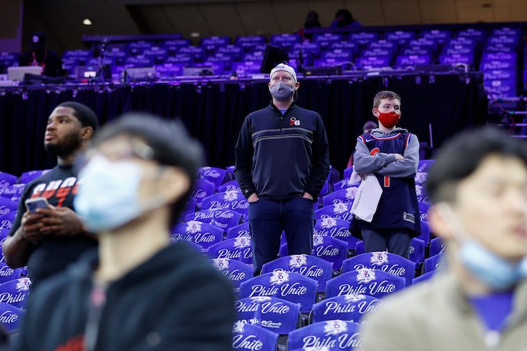 Masked Sixers fans watched pregame warm-ups before the Sixers' Monday playoff game against the Toronto Raptors, during Philadelphia's short-lived revival of an indoor mask mandate.